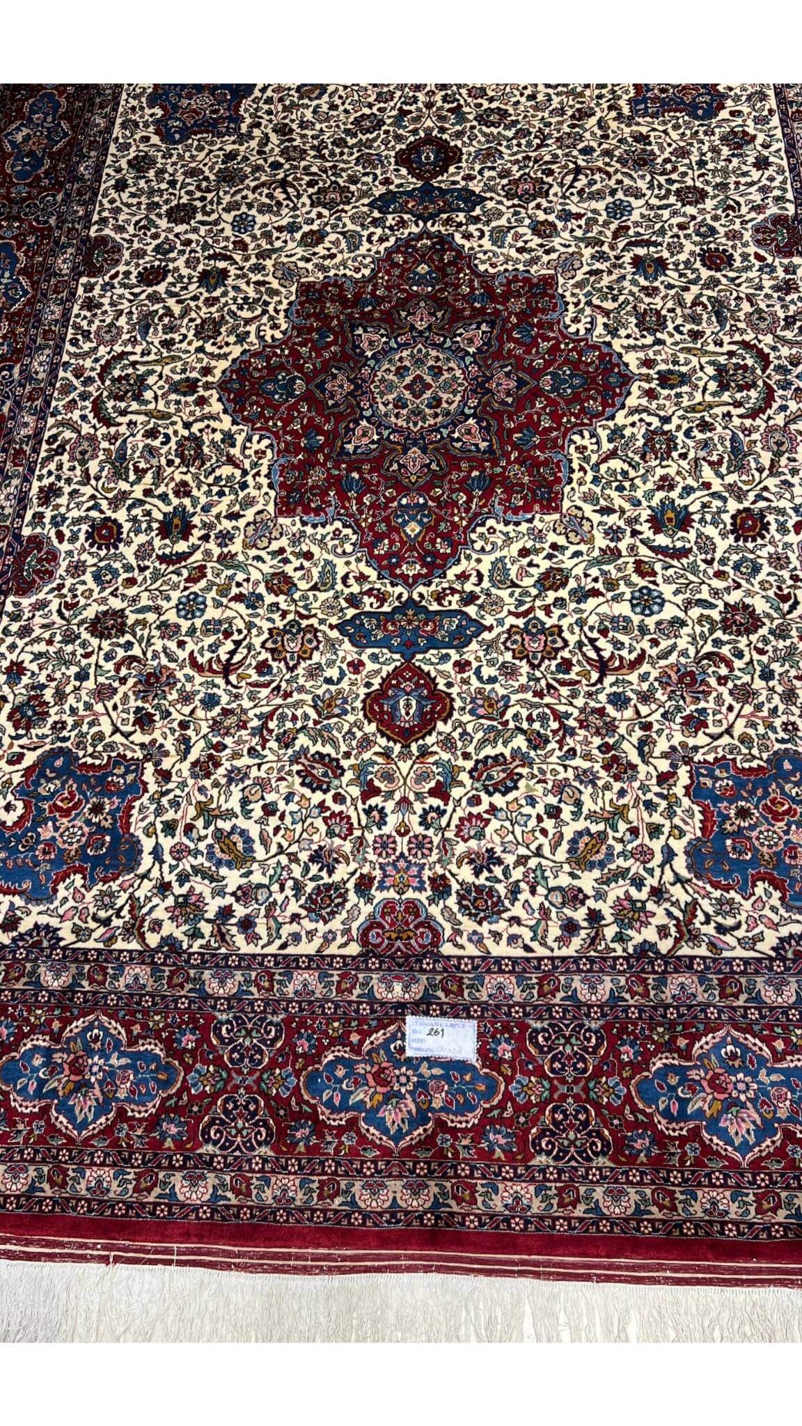 "70-year-old Isfahan rug, hand-knotted with traditional Persian craftsmanship"